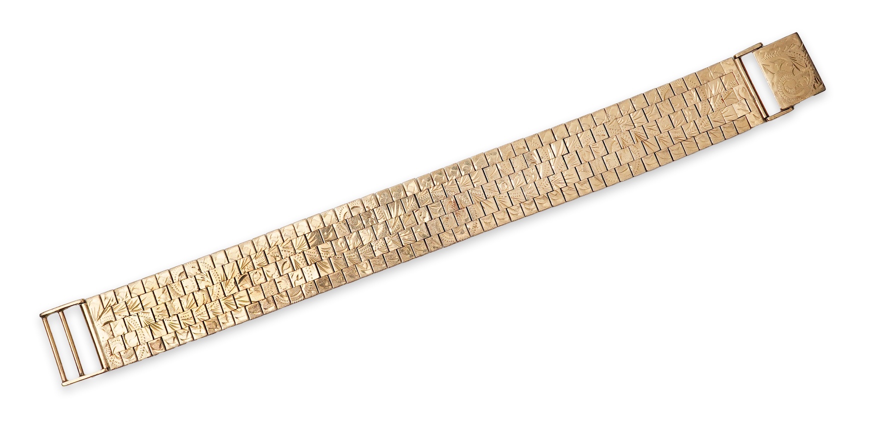 A 9ct gold bracelet, circa 1979, composed of brick linking, engraved to one side with a foliate scroll design, length 19cm, British hallmarks, gross weight approximately 44 grams